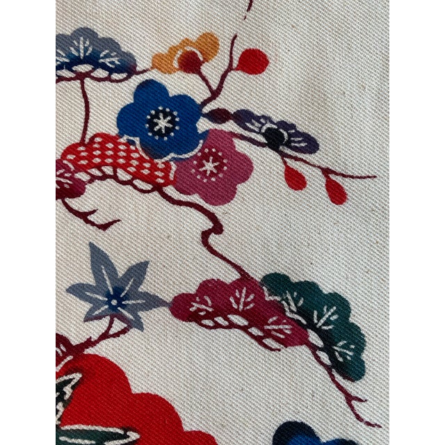 Vintage Japanese cotton textile panel featuring a stylized bird-and-floral landscape framed by deep indigo borders and...