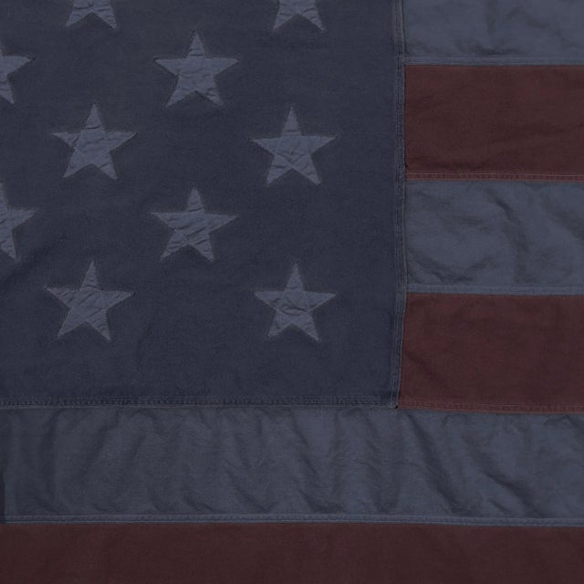 This oversize vintage American flag has been newly overdyed to muted dark blue and burgundy coloring. Made from a cotton...