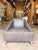 Contemporary leather accent chair featuring a bold architectural silhouette with clean lines and angled track arms for a...