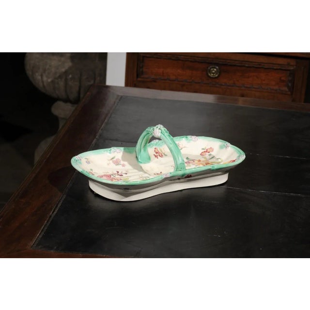 A French Longchamp Majolica asparagus server from the 19th century, with floral decor and C-scroll handle. Born in France...