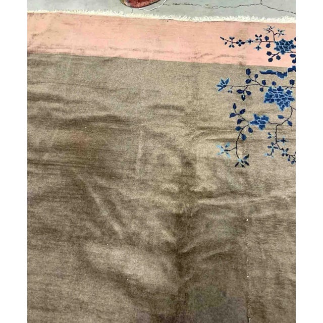 Handmade antique Art Deco Chinese rug in olive green and peach shades. The rug is from the beginning of 20th century in...