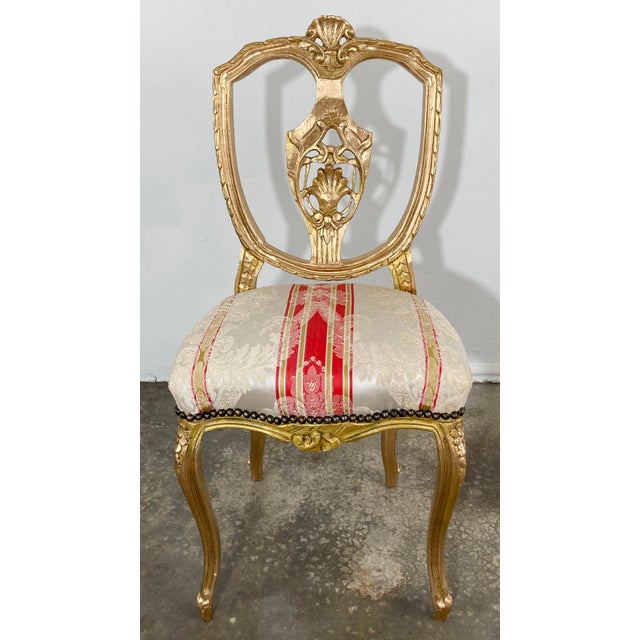 Vintage Venetian style side chair with gilt paint to beautiful decorative carved wood frame. Striking striped damask...