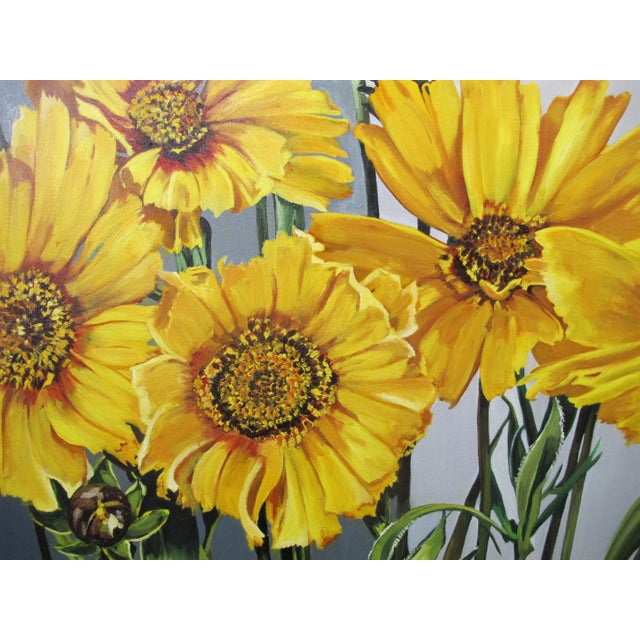 Oil painting on canvas of bold sunflowers. Signed Slater at lower right. Measures 30" x 23.75".
