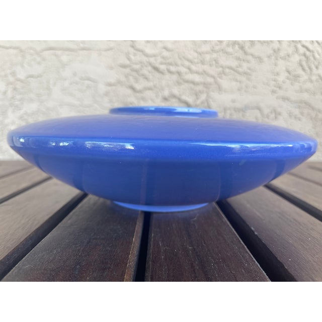 This item is a cobalt blue ceramic ikebana vase, often referred to as a "flying saucer" or "UFO" shape due to its wide,...
