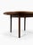 Extendable round teak table made in Italy in the 1960s. The table comes with four chairs upholstered in black faux...