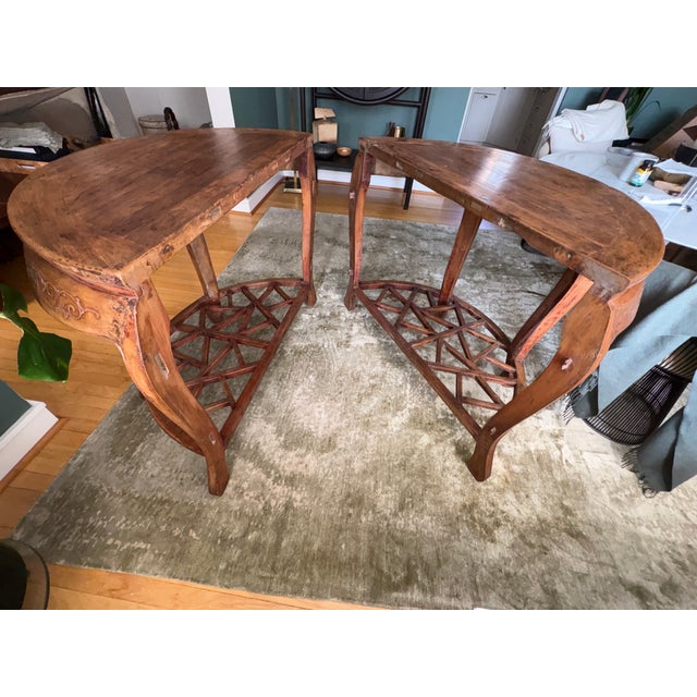 This is a gorgeous pair of antique 18th century Qing Dynasty Chinese demilune tables. They feature beautiful carved...