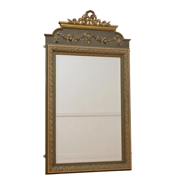 Attractive French wall mirror, having original bevelled edge glass in moulded and flower carved gilded frame with floral...