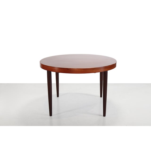 Round dining table produced in Denmark in sept 1969. The table is made of beautiful dark veneer and finished with solid...