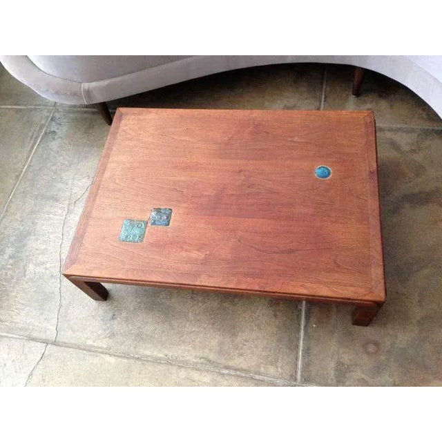 A rare low 1950s sculptural walnut cocktail table with inset Natzler tiles. Measures: 18" H x 30" W x 22" W x 60" L.