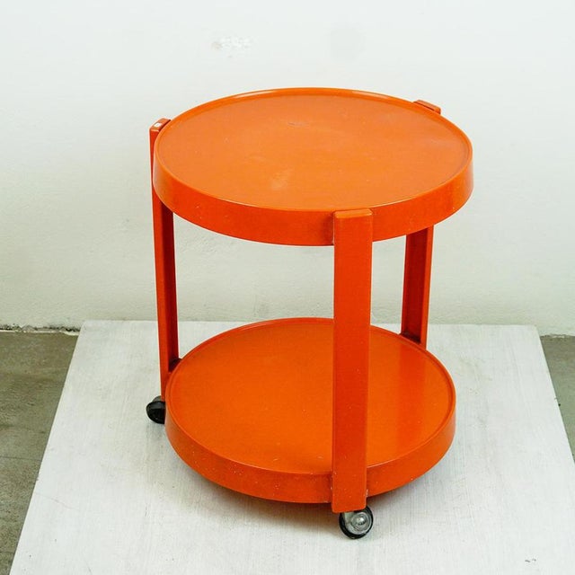Striking vintage plastic bar cart from the 1970s, a true testament to Italys iconic design era. Crafted in bold orange...