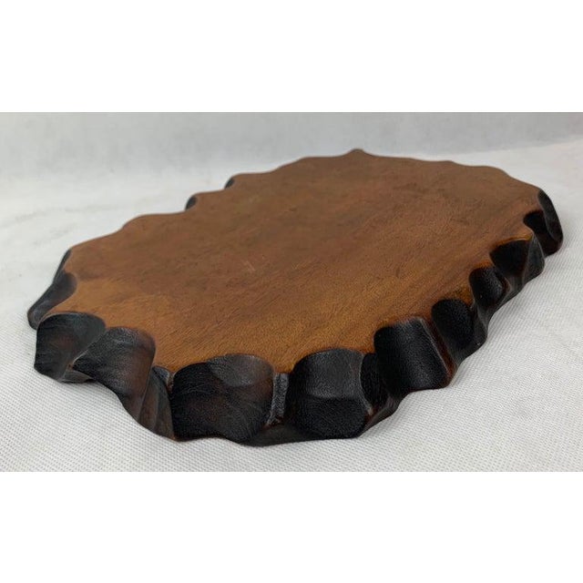 Large Chinese free form hand carved wood display stand with dark stained naturalistic border. Probably created to display...