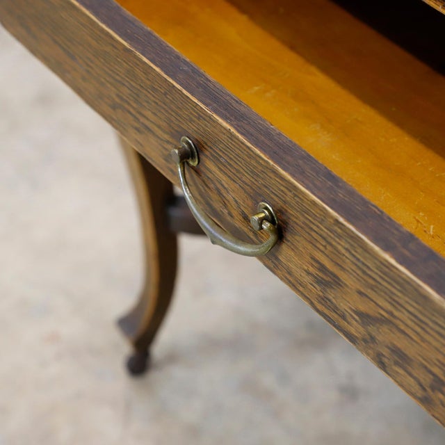 Circa 1920 we offer this Solid Antique Oak Writing Table.