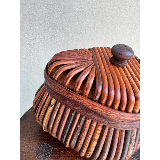A beautifully crafted lidded jewelry box constructed from densely bundled split bamboo canes arranged vertically around a...