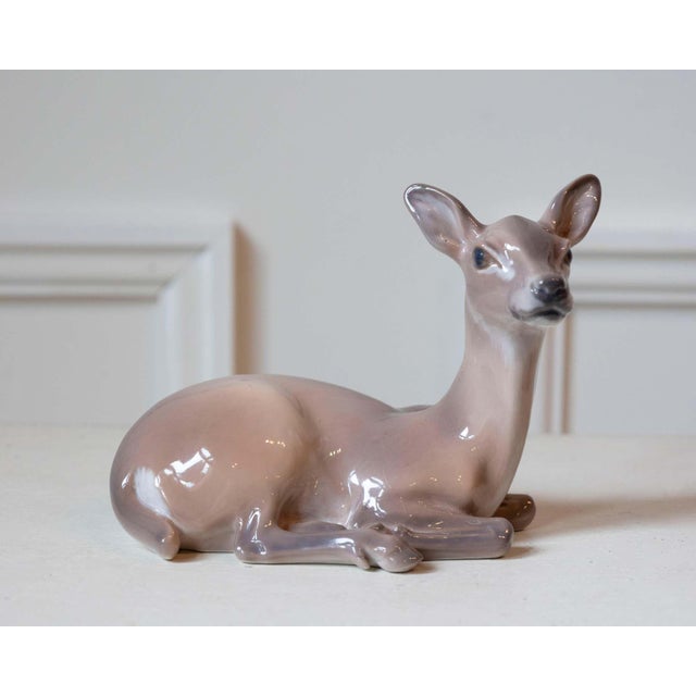 An exquisite porcelain deer by Danish sculptor Dahl Jensen, celebrated for his masterful naturalism and refined...