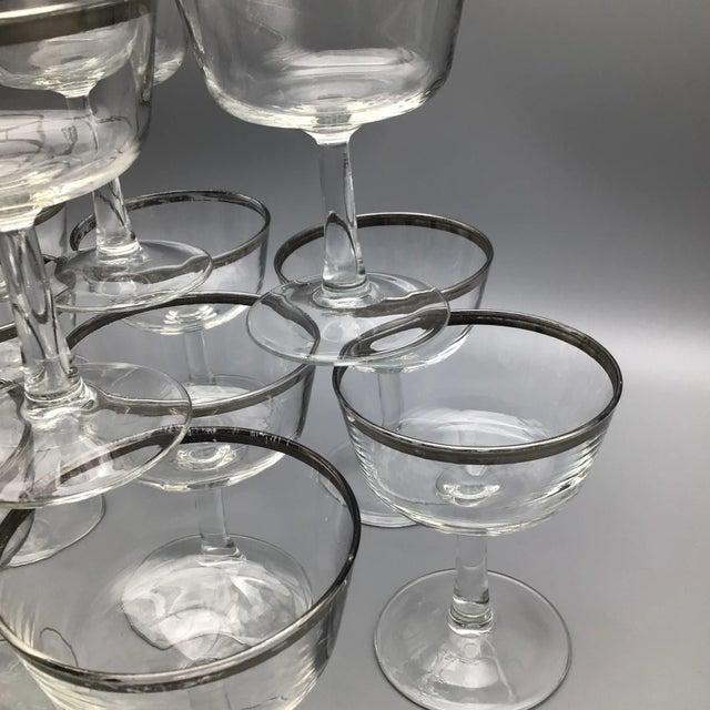 Set of 11 platinum rim champagne crystal coupes/sherbet glasses with raised “France” lettering on the bottom.