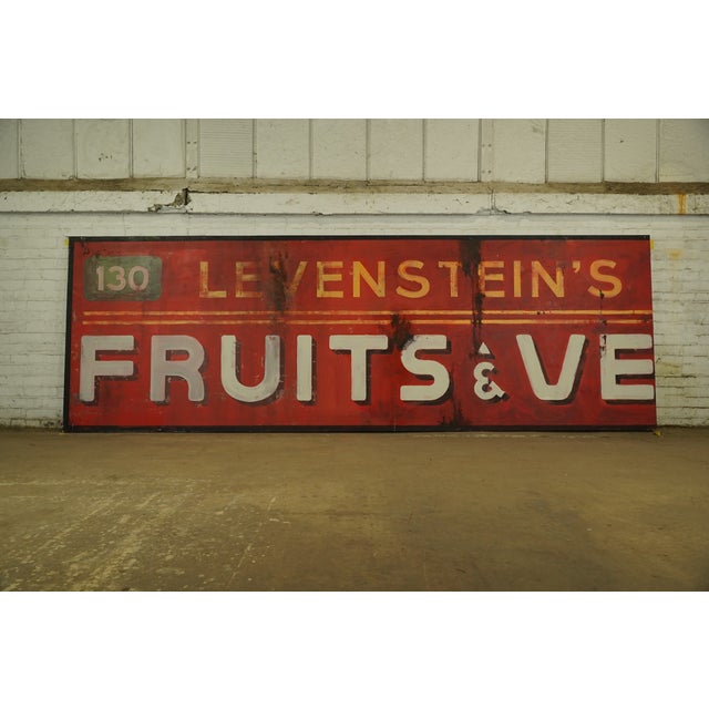 Reclaimed movie set signs made of aluminum in yellow, red, green, white and black colors. The sign reads "Levestein's Food...