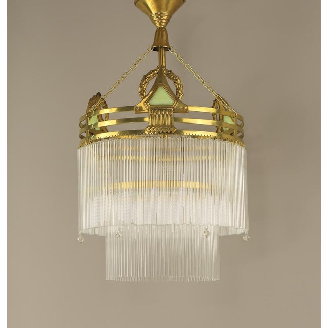 Brass chandelier with cut lind green glass prisms. Polished surface. The luminaire has been rewired according to current...