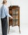 A delicate Edwardian cabinet featuring fine inlay work and elegant proportions. The decorative marquetry highlights...