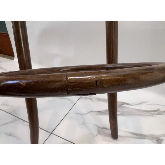 Pair of vintage bentwood bar stools with caned rattan seats, marked Made in Yugoslavia. Each features classic Thonet-style...