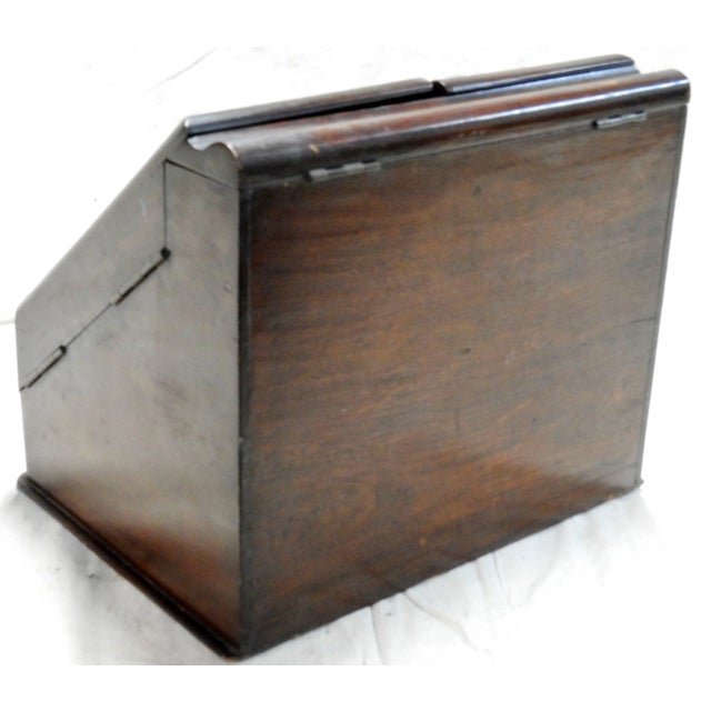 This walnut desk organizer is full of hidden compartments. It was made in England in the early 20th Century. The top...
