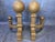 An antique pair of very heavy cast iron cannonball fireplace andirons. Recently powder coated in an antique finish. A bold...