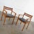 Stunning Scandinavian Modern teak pair of armchairs with their original brushed charcoal fabric seat cushions. These are...