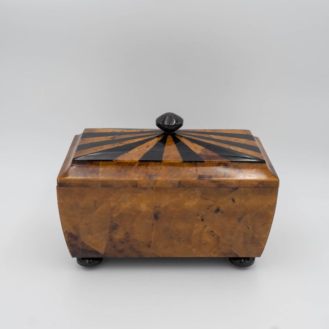 A striking tessellated tiger pen shell casket-form desk box featuring a domed top with a contrasting sunburst inlay. This...
