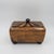 A striking tessellated tiger pen shell casket-form desk box featuring a domed top with a contrasting sunburst inlay. This...