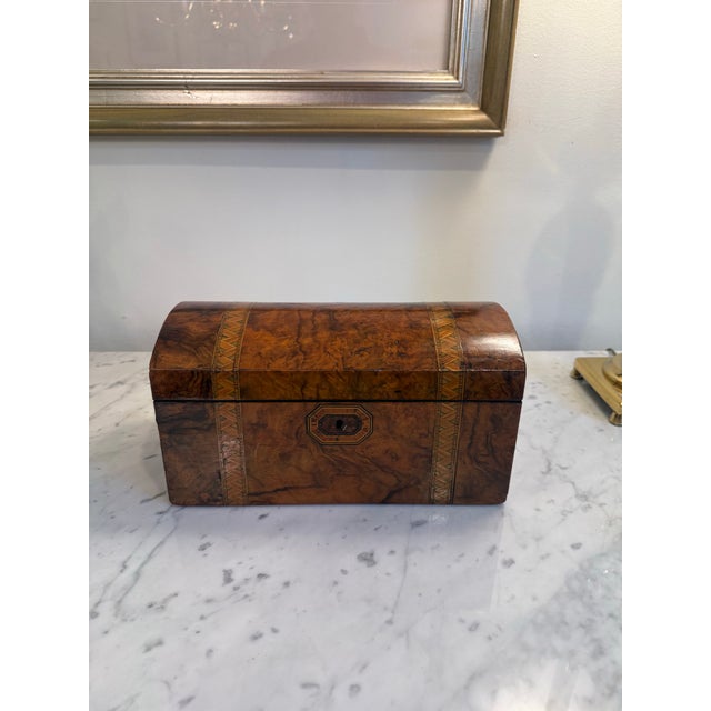 A beautiful 19th-century English Victorian tea caddy, circa 1870, crafted in richly figured burr walnut and embellished...