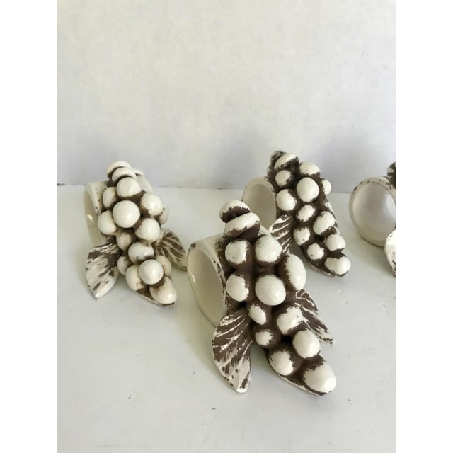 This is a set of 6 beautifully, hand-made pottery napkin rings in the shape of a draped cluster of grapes, grape leaves...