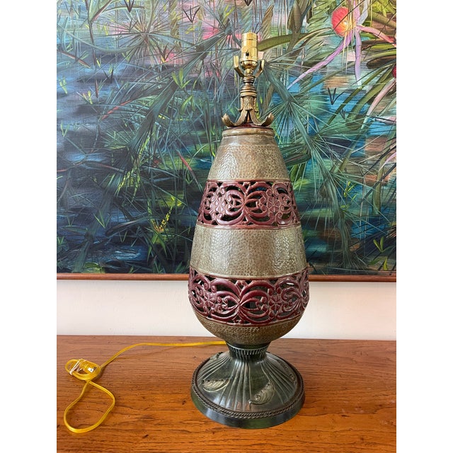 Striking oversized table lamp by John Richard, featuring a sculptural urn form with hammered metal surfaces and decorative...