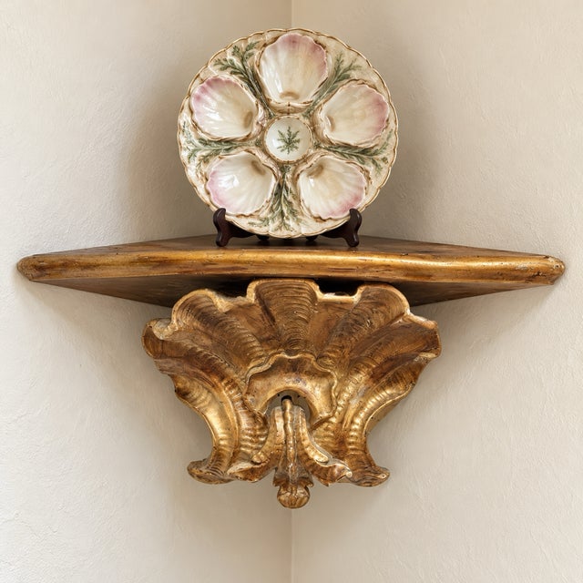 This is a large scale Italian Hollywood Regency era carved giltwood grotto inspired scallop shell corner wall bracket. It...