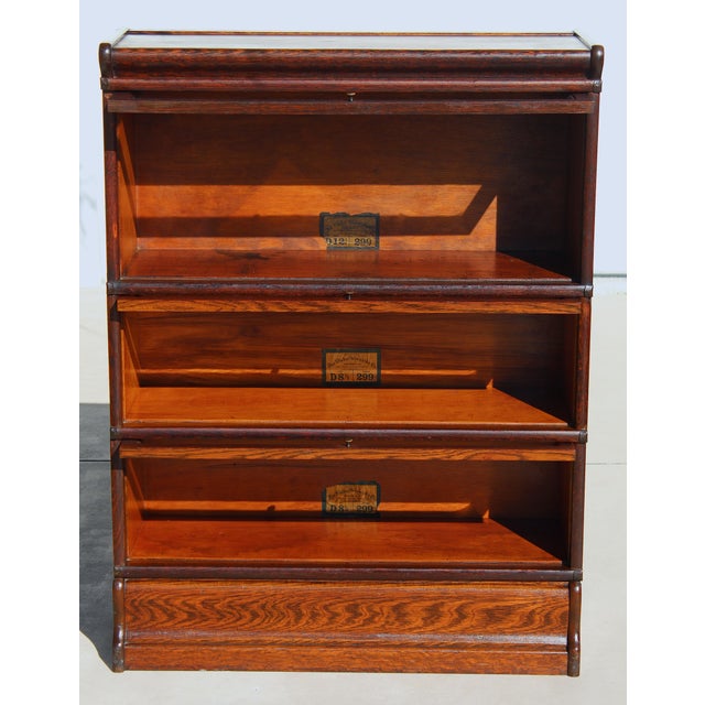 Beautiful early 20th-century Globe Wernicke 3-tier barrister bookcase, crafted in quarter-sawn tiger oak with a rich...