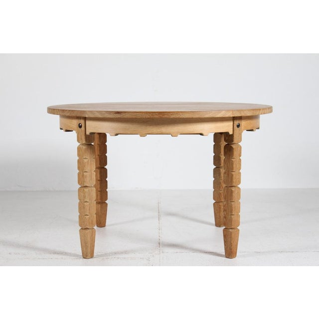 Danish vintage Henning Kjærnulf style round extendable dining table manufactured in Denmark in the 1970s. The table is...