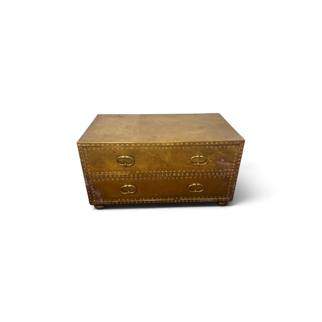 A striking vintage brass-clad chest by Sarreid Ltd., handcrafted in Spain. The substantial rectangular case is completely...