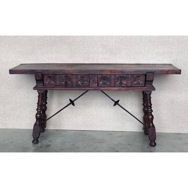 This large Spanish 19th century features a beautiful one plank rectangular top over a two carved drawer featuring slightly...