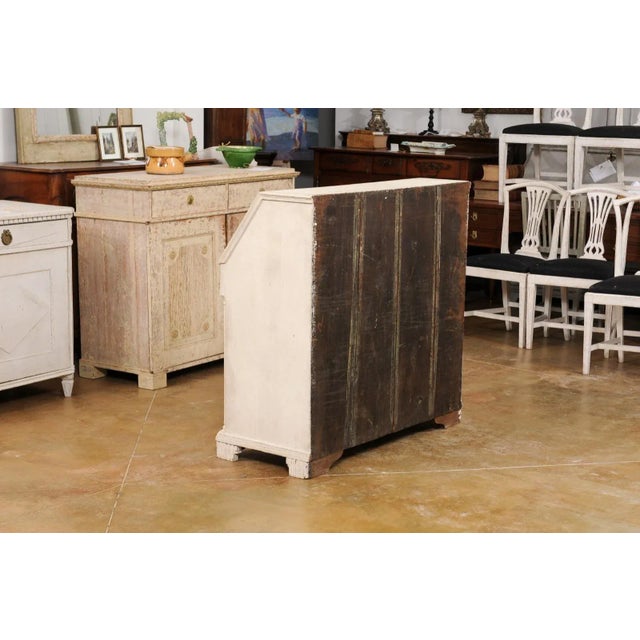 A Swedish Gustavian period slant front desk from the late 18th century, with carved diamond motifs, multiple drawers,...