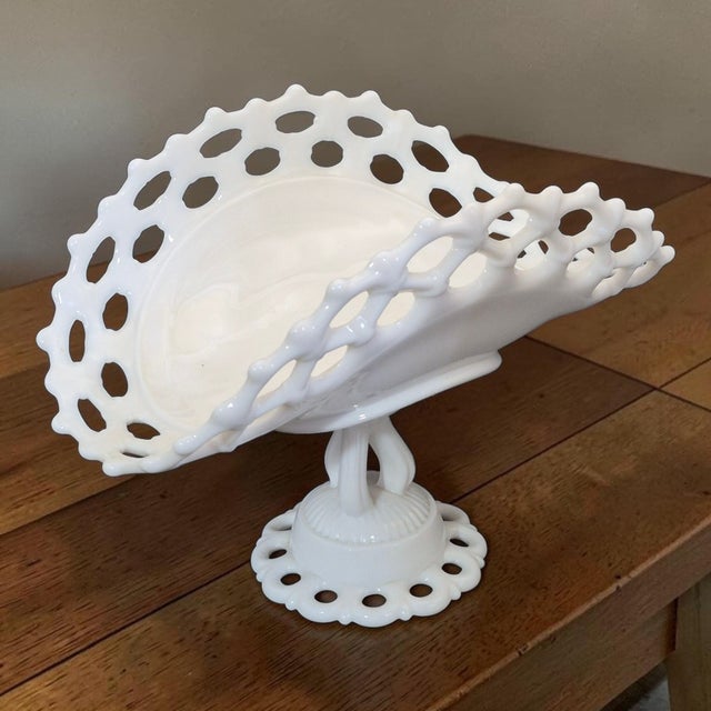 The Westmoreland Milk Glass Lace Pedestal Center Piece Oval Basket Serving Platter is a vintage decorative bowl...