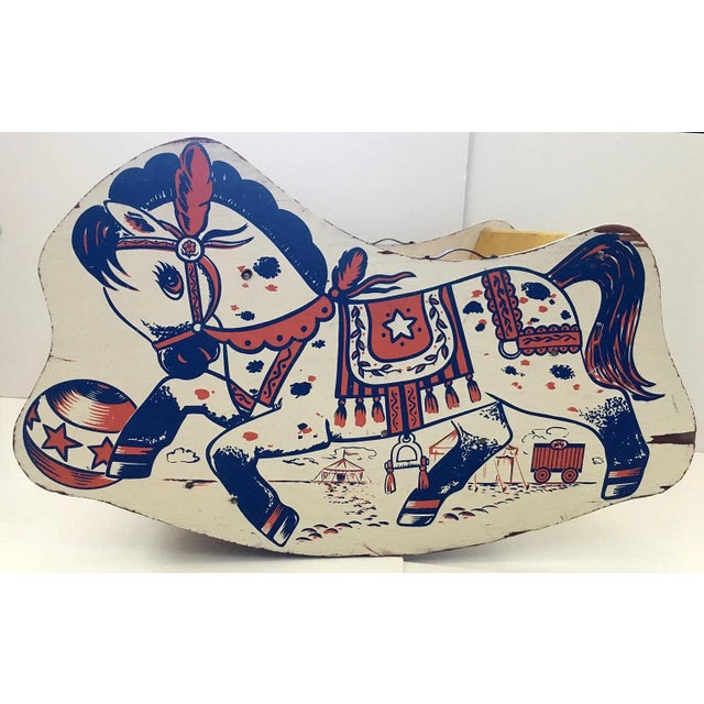 Children's wooden rocking horse chair. Painted reddish-orange, white and blue with a circus theme. Interior seat painted...