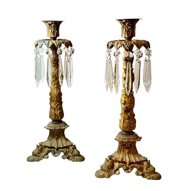 An elegant pair of late 19th century French dore bronze candlesticks, beautifully cast with a richly detailed grapevine...