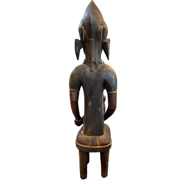 A Large hand carved wooden statue of a Senufo Mother & Child 42" Tall, 11" wide, 10" deep. One of the strongest faiths of...