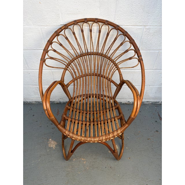A stylish vintage rattan lounge chair from the 1960s–70s, featuring a relaxed silhouette and warm natural texture. Its...