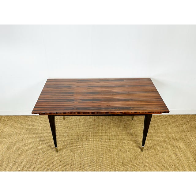 Stunning vintage modernist table from the 1950s, recognizable by its zebrawood veneer, a precious wood prized for its...