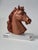Small horse head sculpture on acrylic base This delicate sculpture depicts a finely detailed horse head, crafted from warm...