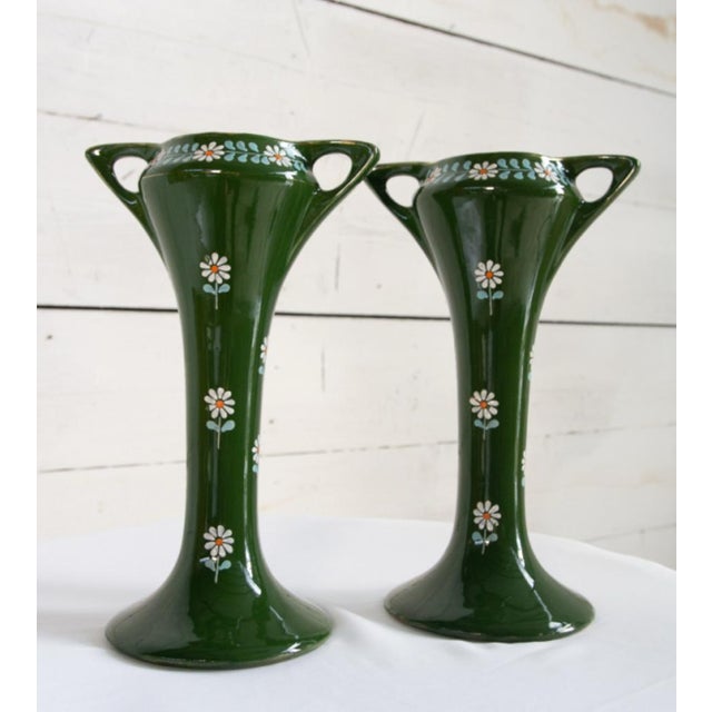 Two tall, elegant vases made of barboutine, with delicate daisies on a green background. The barboutine technique, known...
