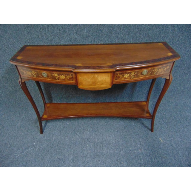 Hepplewhite style Console Table. Made of mahogany inlaid with various exotic woods, 3 drawers with shelf below