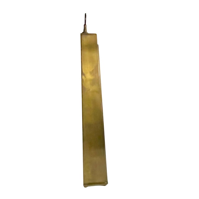 A striking vintage Brutalist wall-mounted curio shelf by Edward Alden, Hong Kong. Crafted in a warm brass-tone metal with...