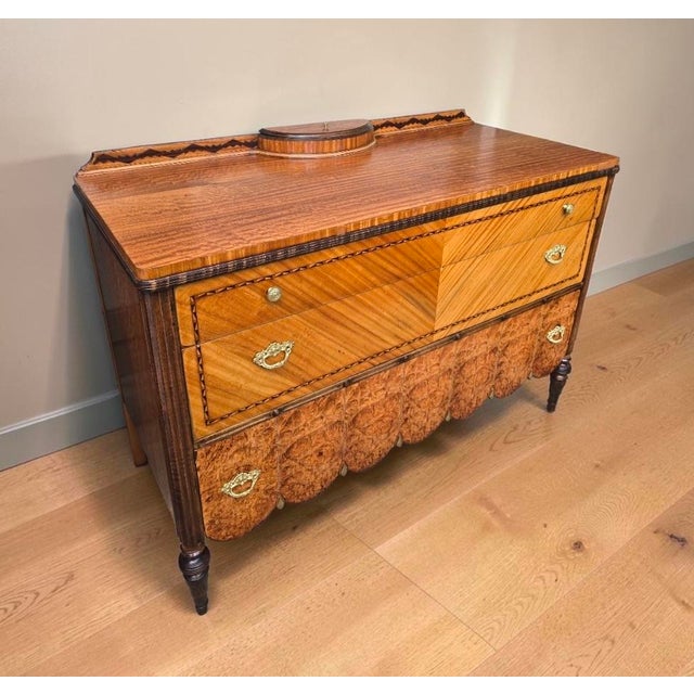 Absolutely beautiful antique chest of drawers / entryway commode with incredible craftsmanship. This statement piece...