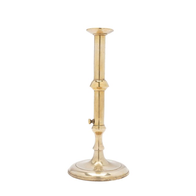 English Georgian cast brass cannon barrel candlestick with external push-up. The candlestick is a seam cast construction...