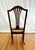 Vintage cane seat rocking chair crafted in the British Colonial / English style, featuring a classic silhouette with...